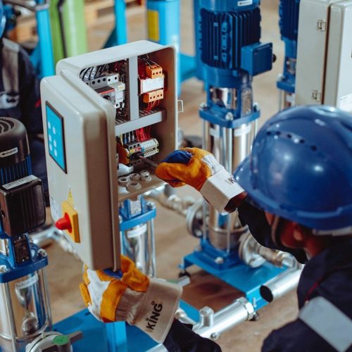 a man working on a machine in a factory
